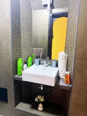 a bathroom with a white sink and a mirror at Beautiful apartment in a very good location and free parking in Marrakech