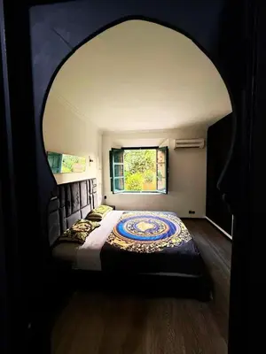 a bedroom with a large bed with a window at Beautiful apartment in a very good location and free parking in Marrakech