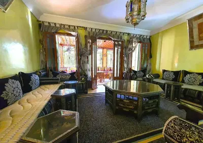 a living room with a couch and a table at Apartment with pool and garden in Marrakech