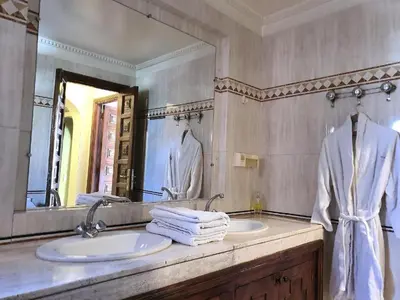 a bathroom with a sink and a mirror at Apartment with pool and garden in Marrakech