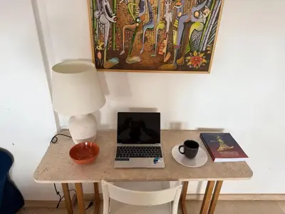 a table with a laptop computer and a lamp on it at Lux apartment With a Sunset View in Marrakech