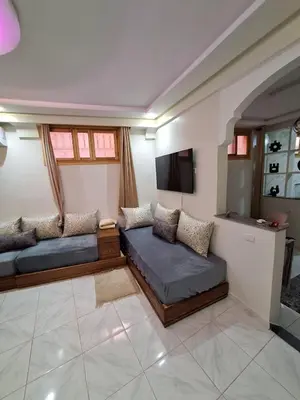 a living room with a couch and a tv at Apartment in Marrakech , Near Jamaa El Fna in Marrakech