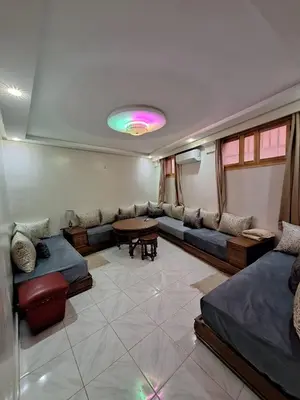 a living room with couches and a table in it at Apartment in Marrakech , Near Jamaa El Fna in Marrakech