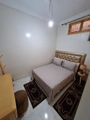a small bedroom with a bed and rugs in it at Apartment in Marrakech , Near Jamaa El Fna in Marrakech