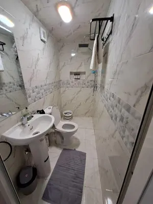 a white bathroom with a sink and a toilet at Apartment in Marrakech , Near Jamaa El Fna in Marrakech