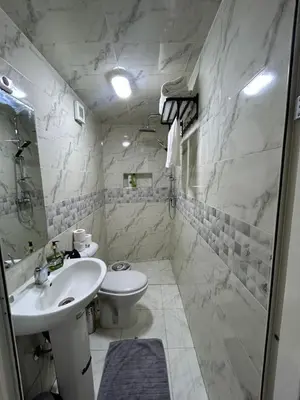 a white bathroom with a sink and a toilet at Apartment in Marrakech , Near Jamaa El Fna in Marrakech