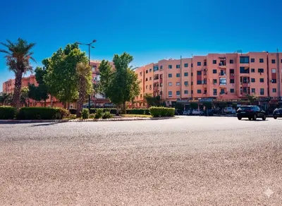 an empty street in front of a large building at Maison Marocaine de Farah in Marrakech