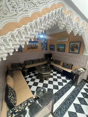 a living room with couches and a checkered floor at Riad& 4 Chambres Avec La piscine in Marrakech