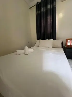 a large white bed in a room with a window at Riad& 4 Chambres Avec La piscine in Marrakech