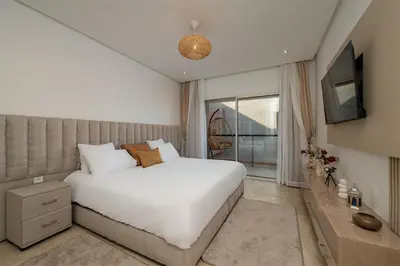 a bedroom with a large white bed and a window at Premium stay in Guéliz-Hivernage in Marrakech