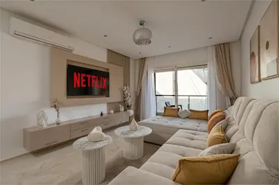 a living room with a couch and a tv at Premium stay in Guéliz-Hivernage in Marrakech