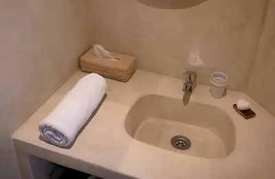 a bathroom sink with a roll of towels on it at Riad privé Dar Sun 2 bassins & Rooftop coeur medina in Marrakech