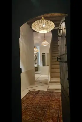 a hallway with a door and a chandelier at Riad privé Dar Sun 2 bassins & Rooftop coeur medina in Marrakech