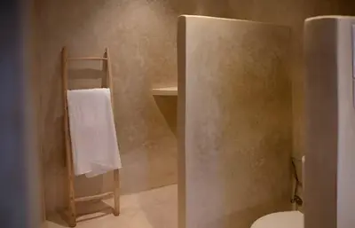 a bathroom with a toilet and a towel rack at Riad privé Dar Sun 2 bassins & Rooftop coeur medina in Marrakech