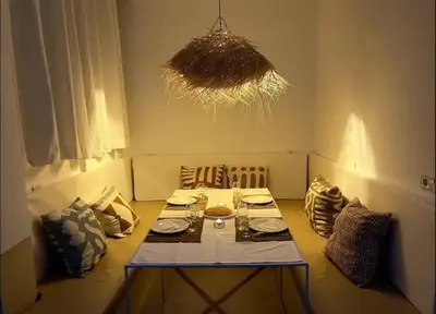 a dining room with a table and a chandelier at Riad privé Dar Sun 2 bassins & Rooftop coeur medina in Marrakech
