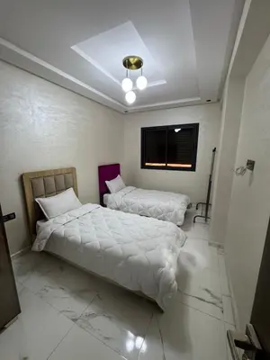 a bedroom with two beds and a window at Feels like home in Marrakech