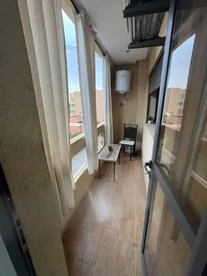 an open door to a room with a table and windows at Feels like home in Marrakech