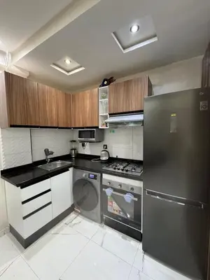 a kitchen with a stainless steel refrigerator and a dishwasher at Feels like home in Marrakech