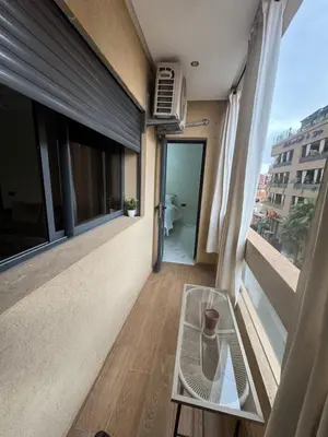 a room with a window with a vase on a table at Feels like home in Marrakech