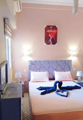 a bedroom with a large bed with a blue headboard at Cozy Apartment Marrakech Airport in Marrakech