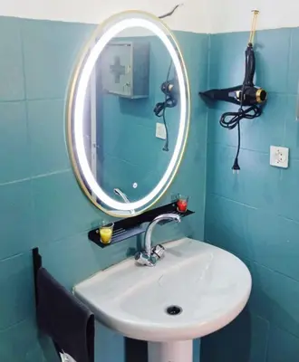 a bathroom with a sink and a mirror at Cozy Apartment Marrakech Airport in Marrakech
