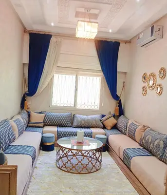 a living room with a couch and a table at Cozy Apartment Marrakech Airport in Marrakech