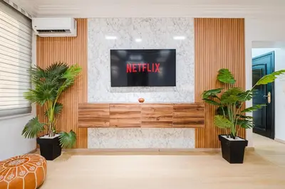 a living room with a television on a wall at Apartment in Center of Marrakech in Marrakech