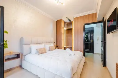 a bedroom with a large white bed in a room at Apartment in Center of Marrakech in Marrakech
