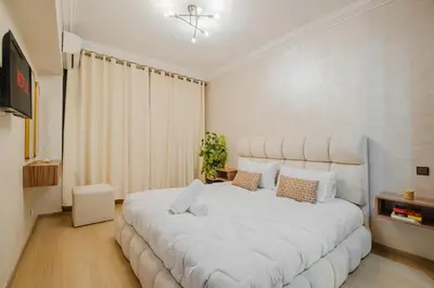 a bedroom with a large white bed in a room at Apartment in Center of Marrakech in Marrakech