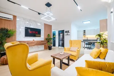 a living room with yellow chairs and a couch at Apartment in Center of Marrakech in Marrakech