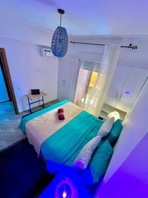 a bedroom with a bed with green and white at Appartement avec piscine privée in Marrakech