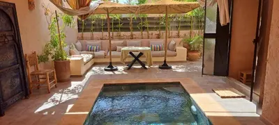 a swimming pool in the middle of a patio at Appartement avec piscine privée in Marrakech