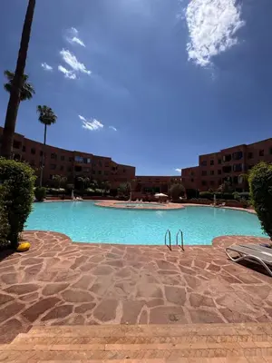 a large swimming pool in front of a building at Superbe appartement Marrakech Piscine Wifi Climatisation in Marrakech