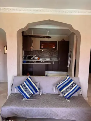 a couch with blue and white pillows in a kitchen at Superbe appartement Marrakech Piscine Wifi Climatisation in Marrakech