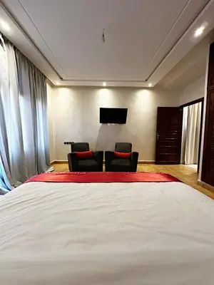 a bedroom with a large white bed and two chairs at Marrakech Escape Your Private Villa in Marrakech