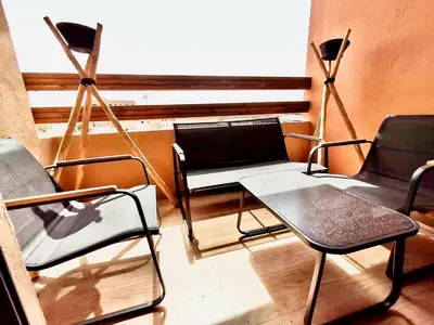 a group of chairs and tables in a room at Appartement a hivernage in Marrakech