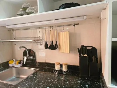 a kitchen counter with a sink and utensils at Residencia Salma in Marrakech