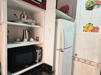 a small kitchen with a refrigerator and a microwave at Residencia Salma in Marrakech