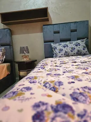a bedroom with a bed with a floral bedspread at Residencia Salma in Marrakech