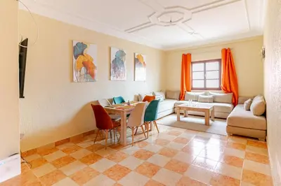 a living room with a table and a couch at Jamila home elegance hospitality fiber WiFi in Marrakech
