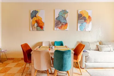 a dining room with a table and chairs and a couch at Jamila home elegance hospitality fiber WiFi in Marrakech