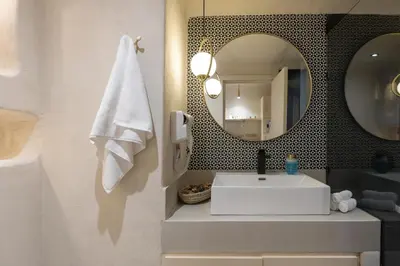 a bathroom with a white sink and a mirror at Boho Nest Gueliz Center, Terrace & Quiet in Marrakech