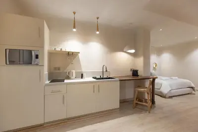 a kitchen with a sink and a bed in a room at Boho Nest Gueliz Center, Terrace & Quiet in Marrakech