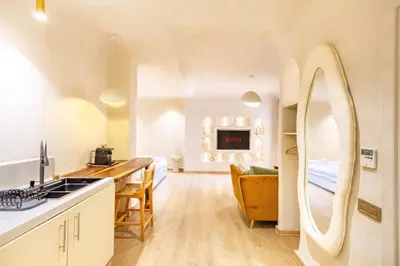 a kitchen and living room with a large mirror at Boho Nest Gueliz Center, Terrace & Quiet in Marrakech