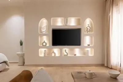 a living room with a tv on the wall at Boho Nest Gueliz Center, Terrace & Quiet in Marrakech