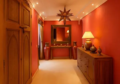 a hallway with a room with red walls and a mirror at Appart AMITAF in Marrakech