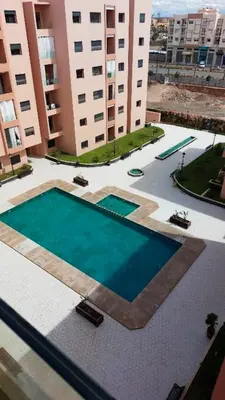a large swimming pool in the middle of a building at Apartment Marrakech Center With Pool in Marrakech