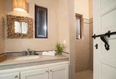 a bathroom with a sink and a mirror at Dar Toozween in Marrakech