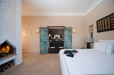 a bedroom with a bed and a fireplace at Dar Toozween in Marrakech