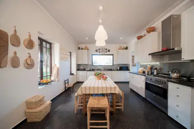 a kitchen with a table and some chairs in it at Dar Toozween in Marrakech